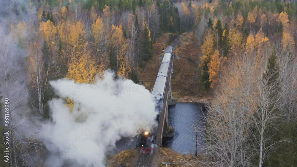 Aerial view steam old locomotive passing the bridge Aerial view steam old locomotive passing the bridge