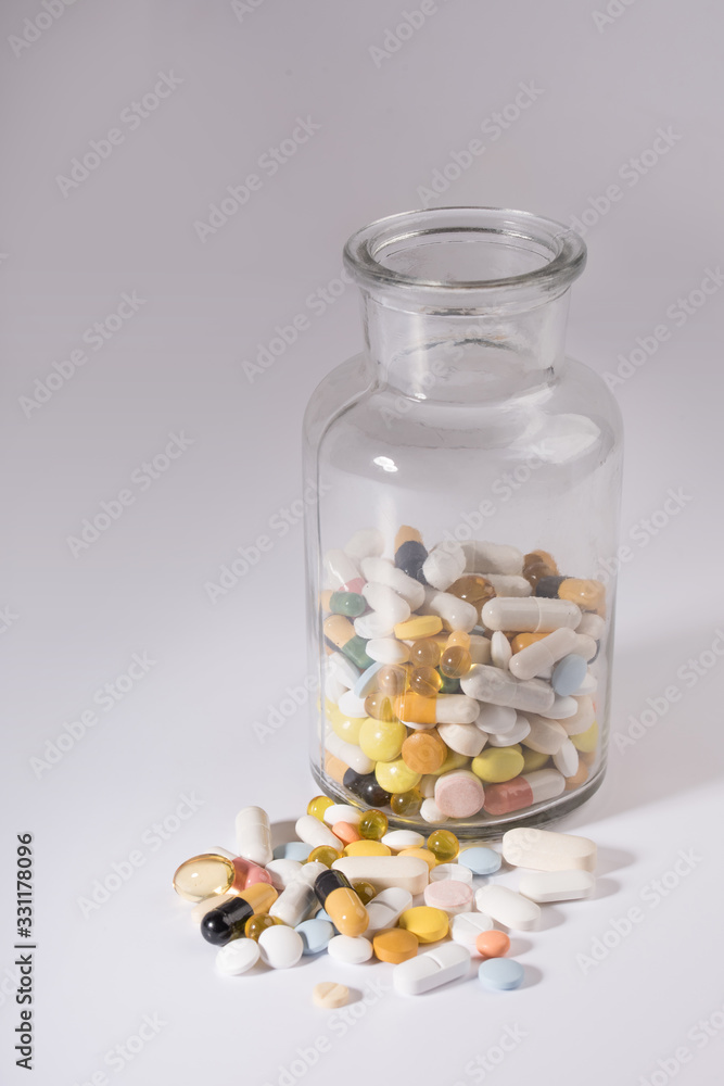 Pills spilled out of pill bottle, top view. Medication and medicine tablets. Copy space. Pills spilled out of pill bottle, top view. Medication and medicine tablets. Copy space.