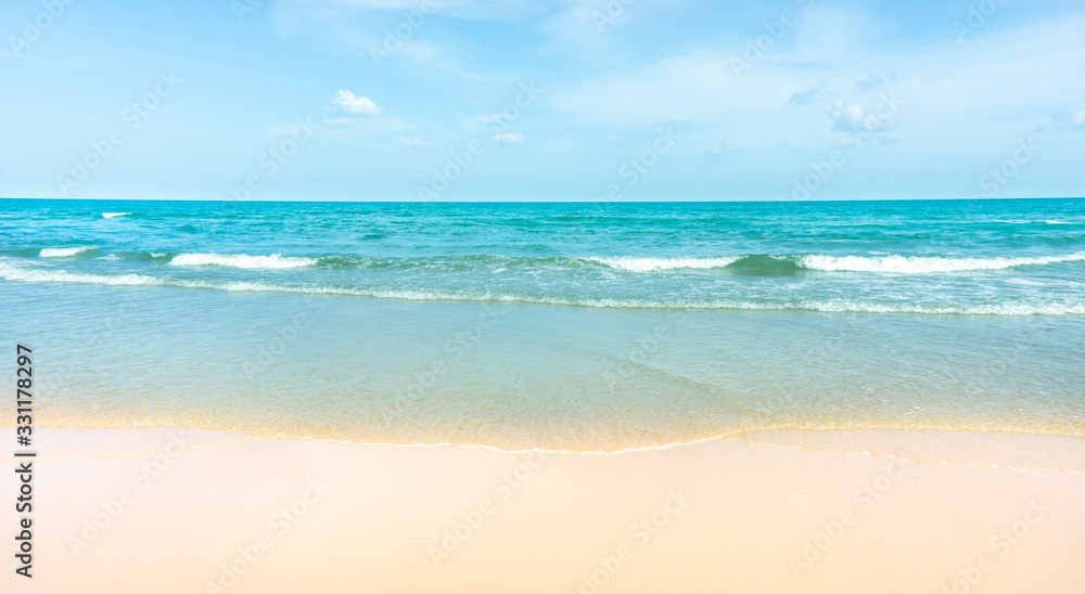 Clean white beach golden brown sand and blue sea under clear blue sky in a sunny day