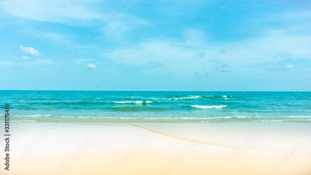 Clean white beach golden brown sand and small wave from blue sea under clear blue sky in a sunny day