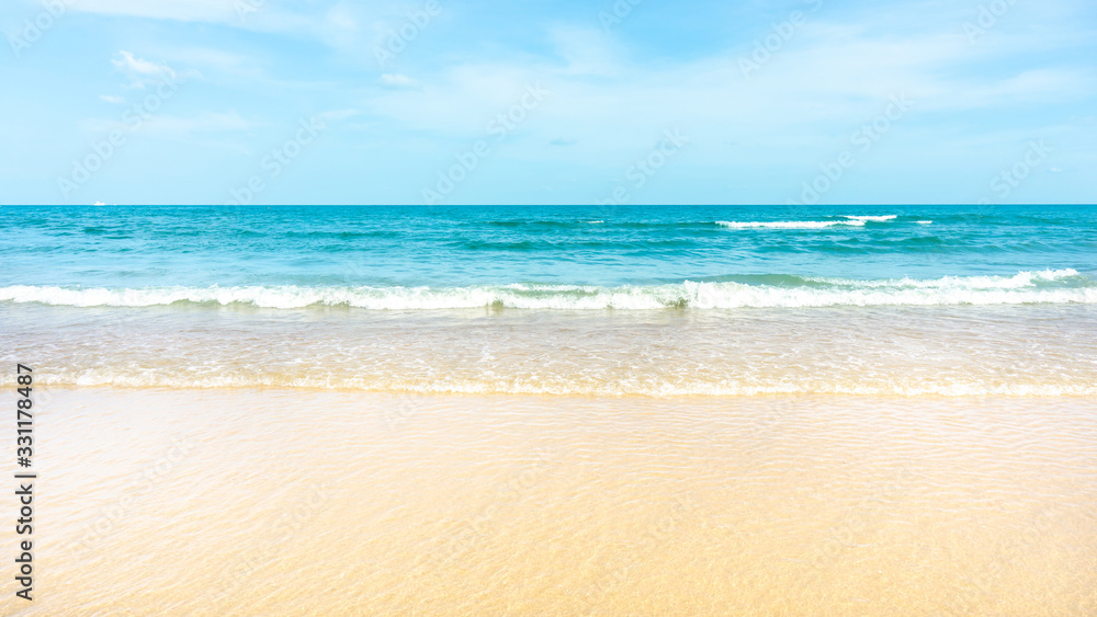 Clean white beach golden brown sand and small wave from blue sea under clear blue sky in a sunny day