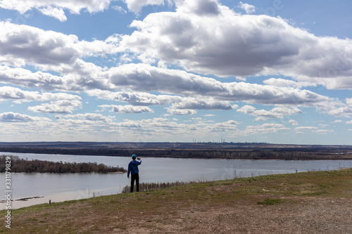 Obraz na płótnie Boy taking photo of river and beautiful sky w salonie