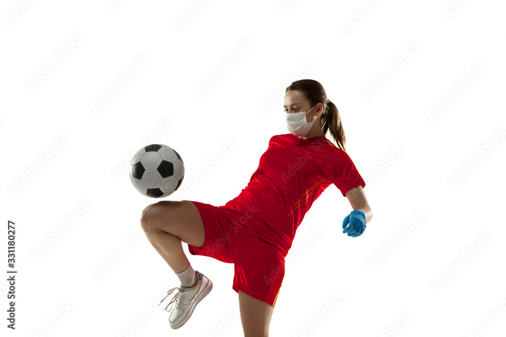 Competition. Female football player in protective mask and gloves. Prevention against pneumonia. Still active while quarantine. Chinese coronavirus treatment. Healthcare, medicine, sport concept.