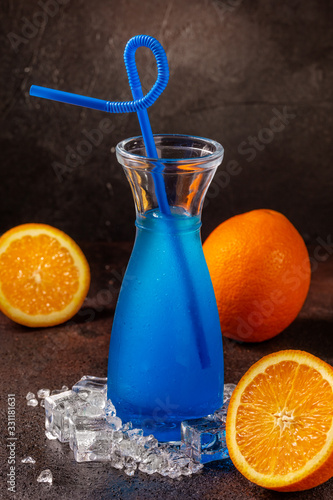 Delicious icy cocktail with fruits on dark grounge background. Healthy colorfull fruit shakes with ice on textured table. photo