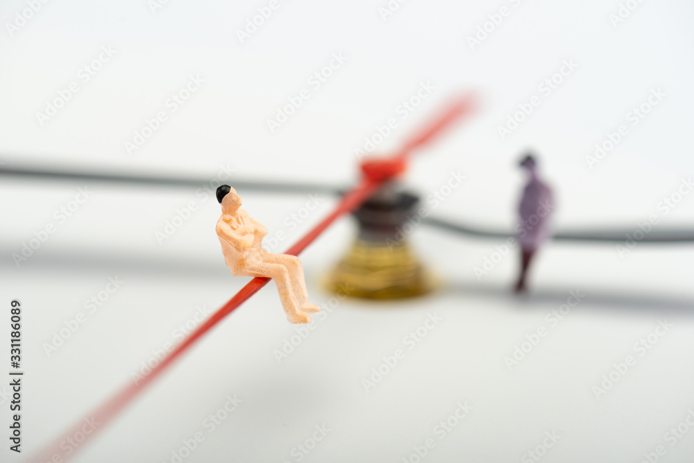 Selective focus of people figures on arrows of clock on grey background, concept of aging Selective focus of people figures on arrows of clock on grey background, concept of aging