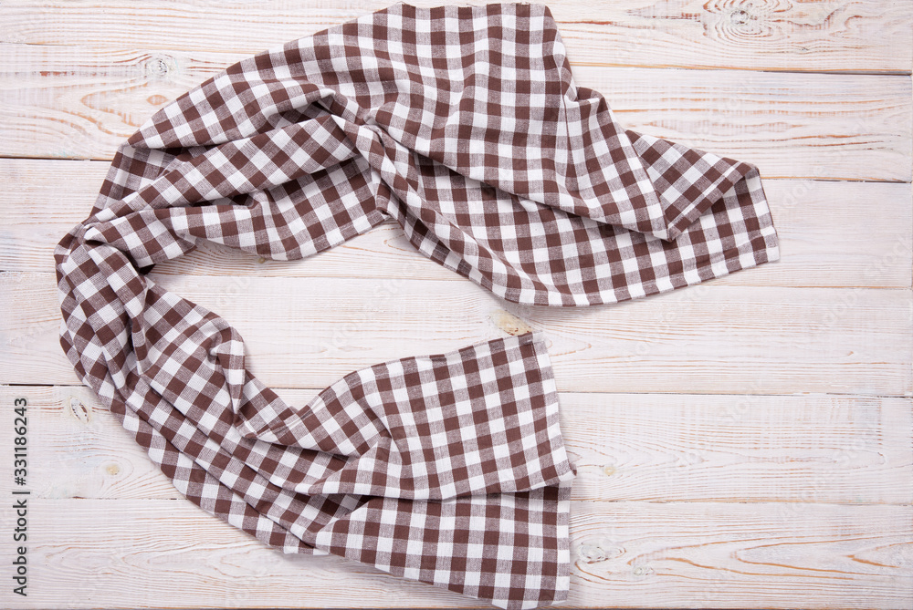 Tablecloth napkin on wood texture. Rustic background. top view. Tablecloth napkin on wood texture. Rustic background. top view.
