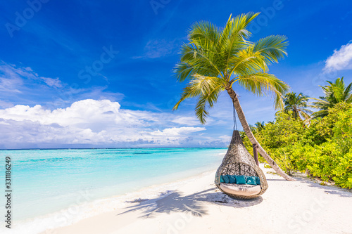 Fototapeta Naklejka Na Ścianę i Meble -  Tropical beach background as summer landscape with beach swing or hammock and white sand and calm sea for beach banner. Perfect beach scene vacation and summer holiday concept. Boost up color process
