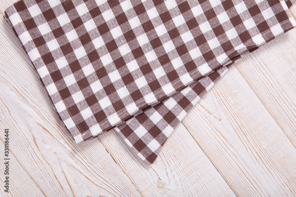 Tablecloth napkin on wood texture. Rustic background. top view. Tablecloth napkin on wood texture. Rustic background. top view.