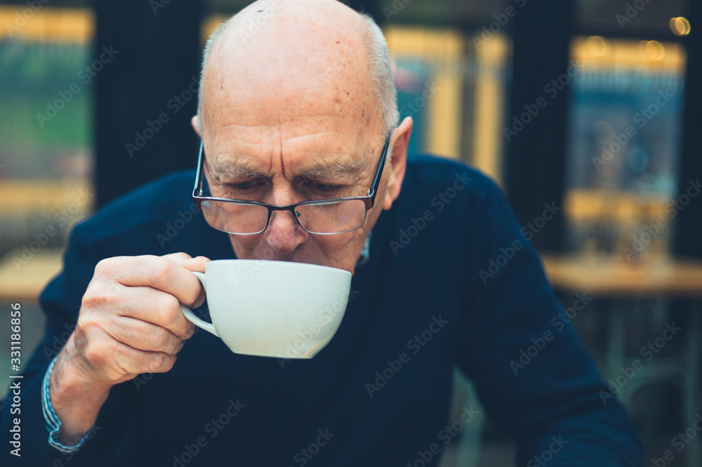 Mature man drinking coffee in cafe Mature man drinking coffee in cafe