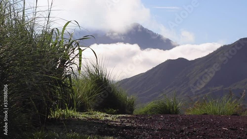 View of volcanoes in the clouds at dawn. Bali, Indonesia