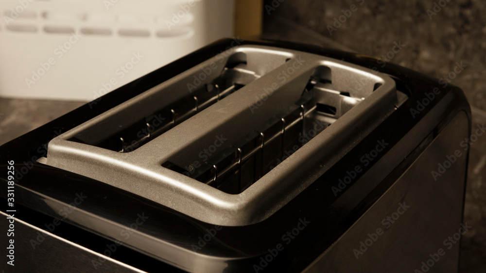 black electric toaster standing in the kitchen close-up black electric toaster standing in the kitchen close-up