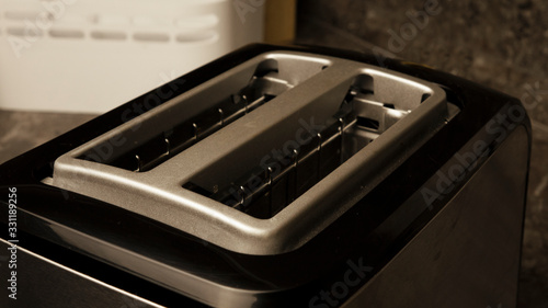black electric toaster standing in the kitchen close-up