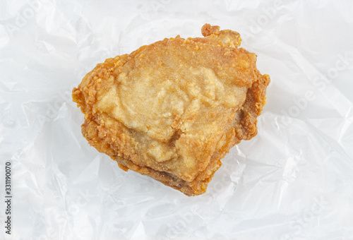 Batter-fried chicken isolated on cooking oil absorbing paper (clipping path included)