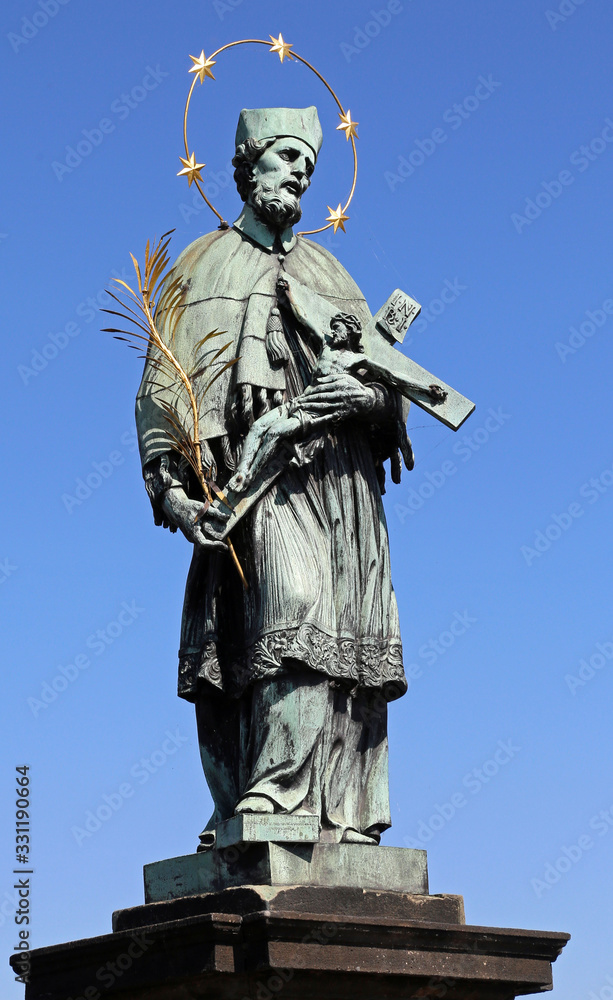 Fototapeta premium statue of Saint John o who holds the crucifix in his hands