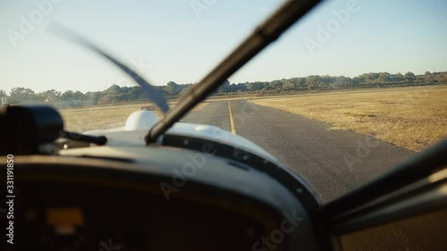 pilot point of view of a small aircraft going down the runway about the depart and take off. shot on a beautiful sunny day with brown dead looking grass around the runway shot in the south of France