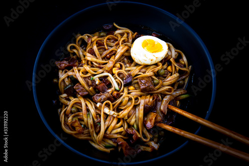 Jajangmyeon, noodle dish topped with black sauce photo