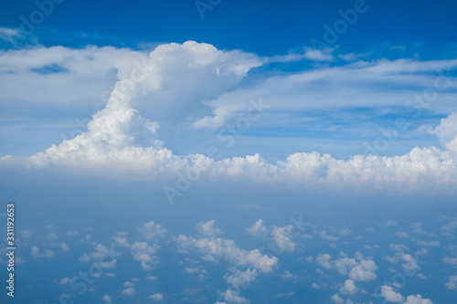 Fototapeta Naklejka Na Ścianę i Meble -  Blue sky with white curly fluffy clouds.