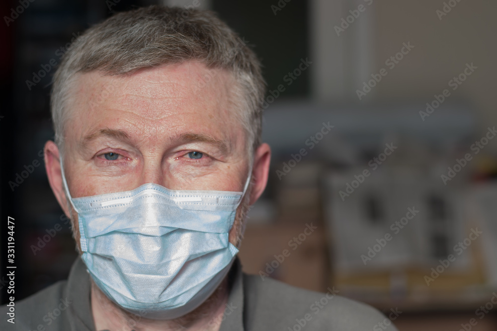 Portrait of a man in a medical mask. The concept of protection and prevention of viral and infectious diseases. Space for text.