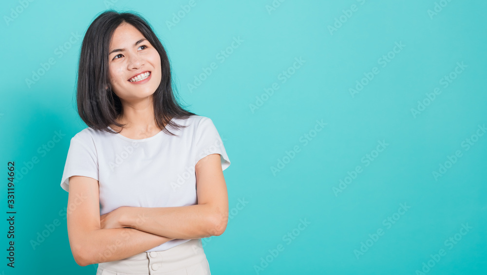 woman smile wear white t-shirt standing with a chest looking up woman smile wear white t-shirt standing with a chest looking up