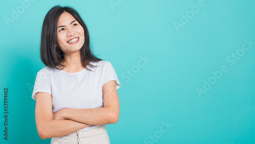 woman smile wear white t-shirt standing with a chest looking up