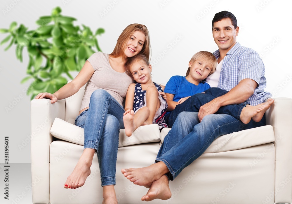 Beautiful smiling lovely family sitting on sofa Beautiful smiling lovely family sitting on sofa