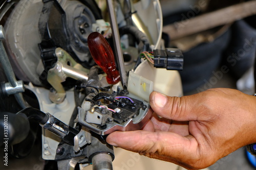 Motorcycle repair technicians check the wiring or repair of the motorcycle.