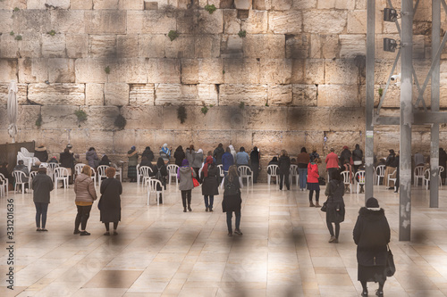 View through the perforated metal enclosure to the female part of the Western Wall in the Old Town of Jerusalem in Israel