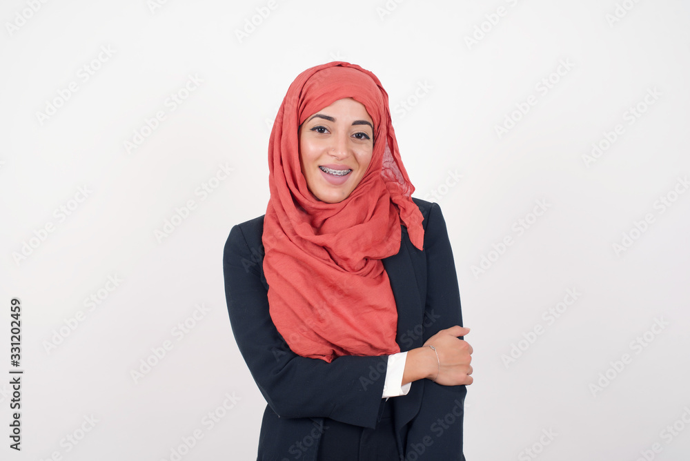 Lovely good-natured young caucasian woman having charming smile and friendly expression holding herself wanting to show her love and sympathy. My heart is for you! Lovely good-natured young caucasian woman having charming smile and friendly expression holding herself wanting to show her love and sympathy. My heart is for you!