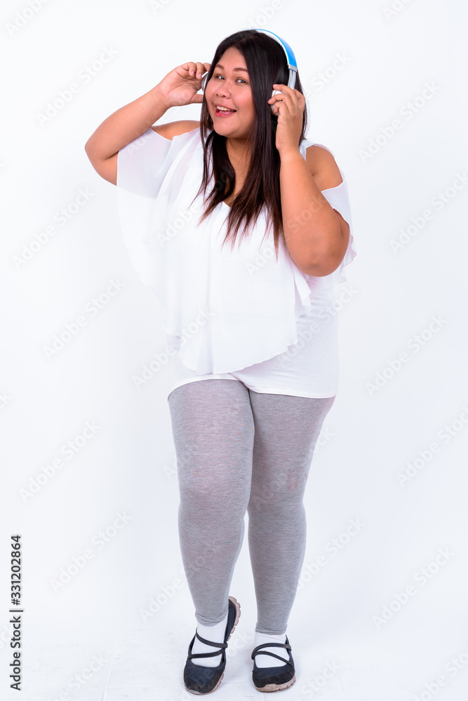 Beautiful overweight Asian woman against white background