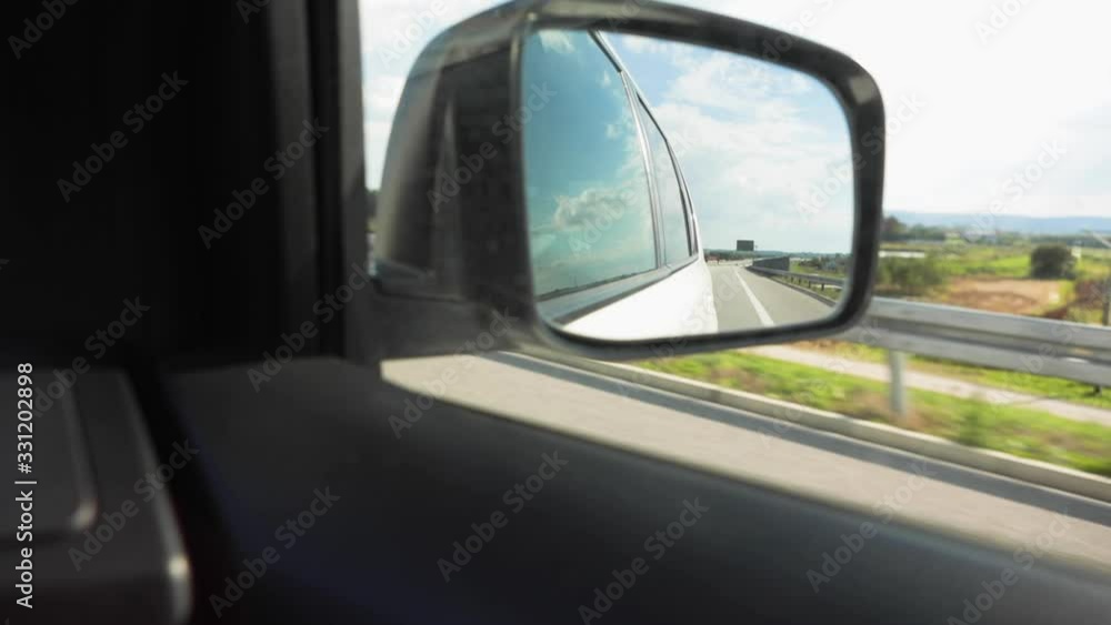 view of highway reflection in car mirror view of highway reflection in car mirror
