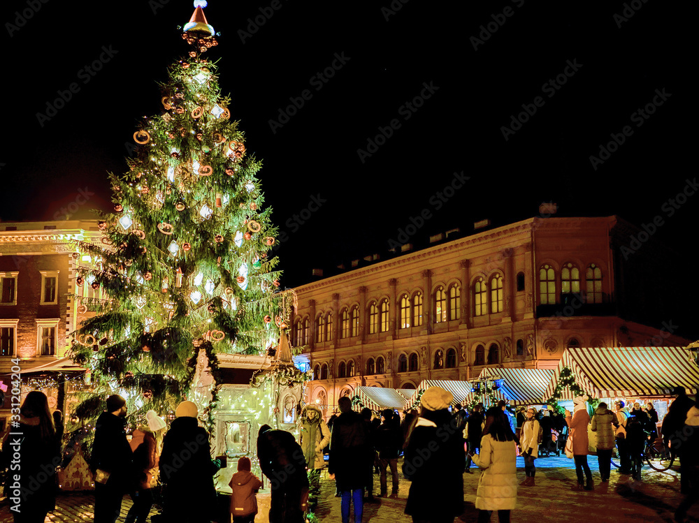 People and Christmas tree at market in Riga Dome square