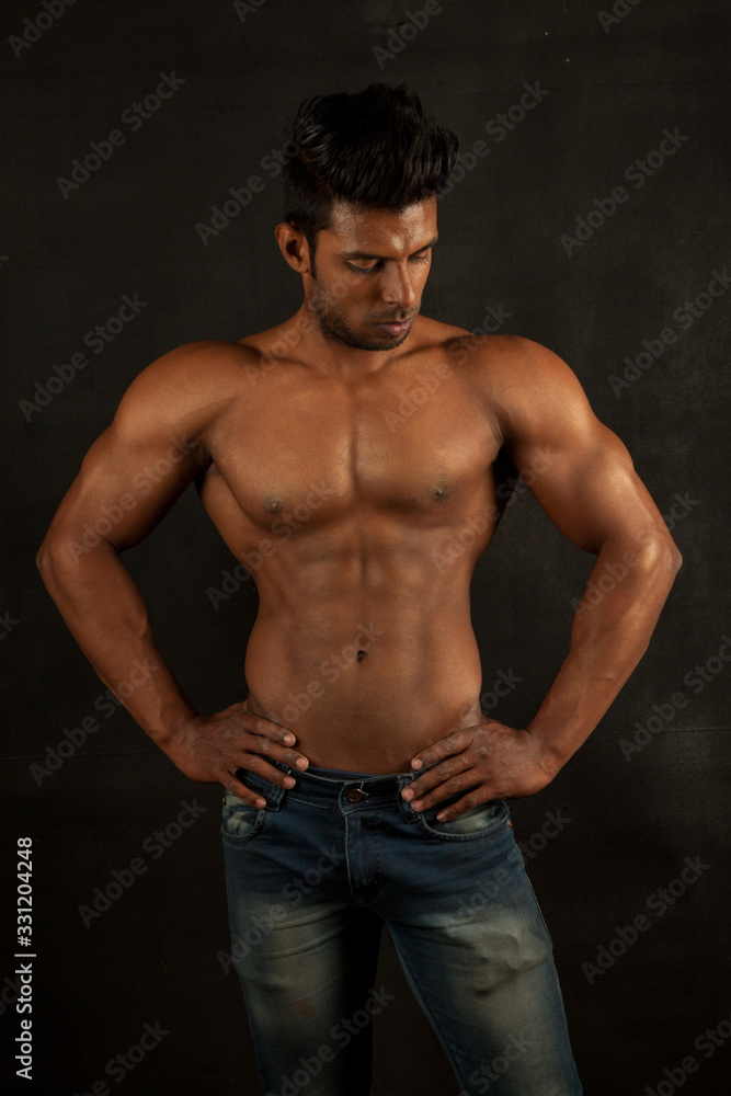 Tanned trainer body builder posing chest athletic body Tanned trainer body builder posing chest athletic body