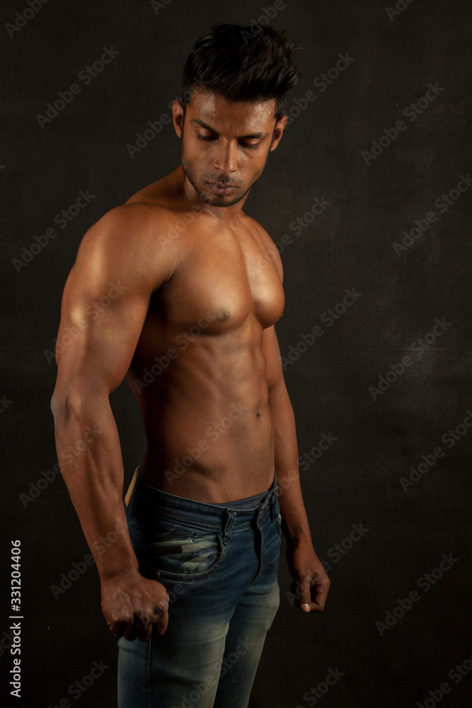 Tanned body builder posing athletic body
