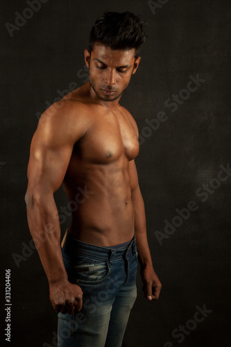 Tanned body builder posing athletic body