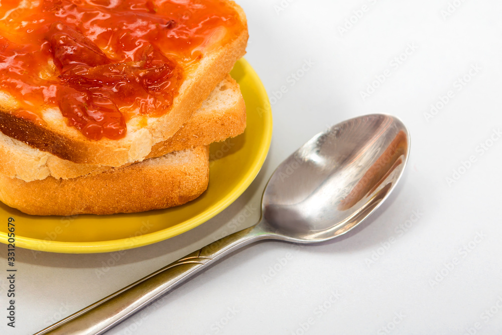Bread and apricot jam on a white background. toast with jam. Dessert for breakfast. Slices of bread with jam. High-calorie sandwiches. Bread and apricot jam on a white background. toast with jam. Dessert for breakfast. Slices of bread with jam. High-calorie sandwiches.