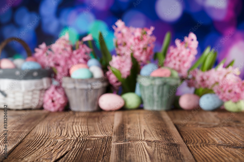 Easter background. Rustic wooden table. Tulips and spring flowers. Easter eggs. Pastel colors bokeh. Easter background. Rustic wooden table. Tulips and spring flowers. Easter eggs. Pastel colors bokeh.