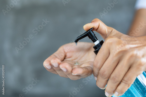 woman disinfecting his hands with hand sanitizer and protection against viruses and bacteria