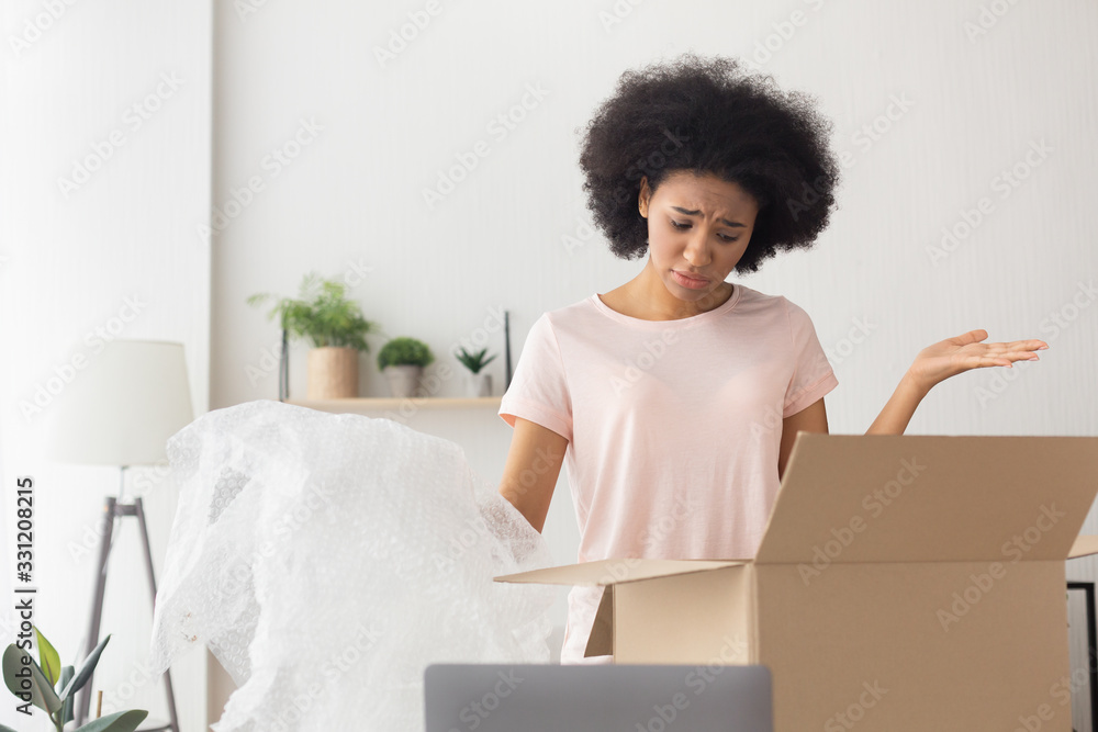 Fototapeta premium African american girl unhappy at delivery from online store