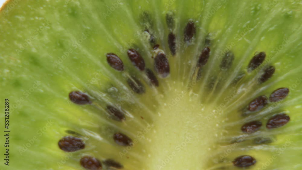 Macro View Of Juicy Sweet Sliced Kiwi on white background Macro View Of Juicy Sweet Sliced Kiwi on white background