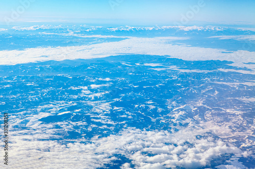 clouds above snowy mountains scenery