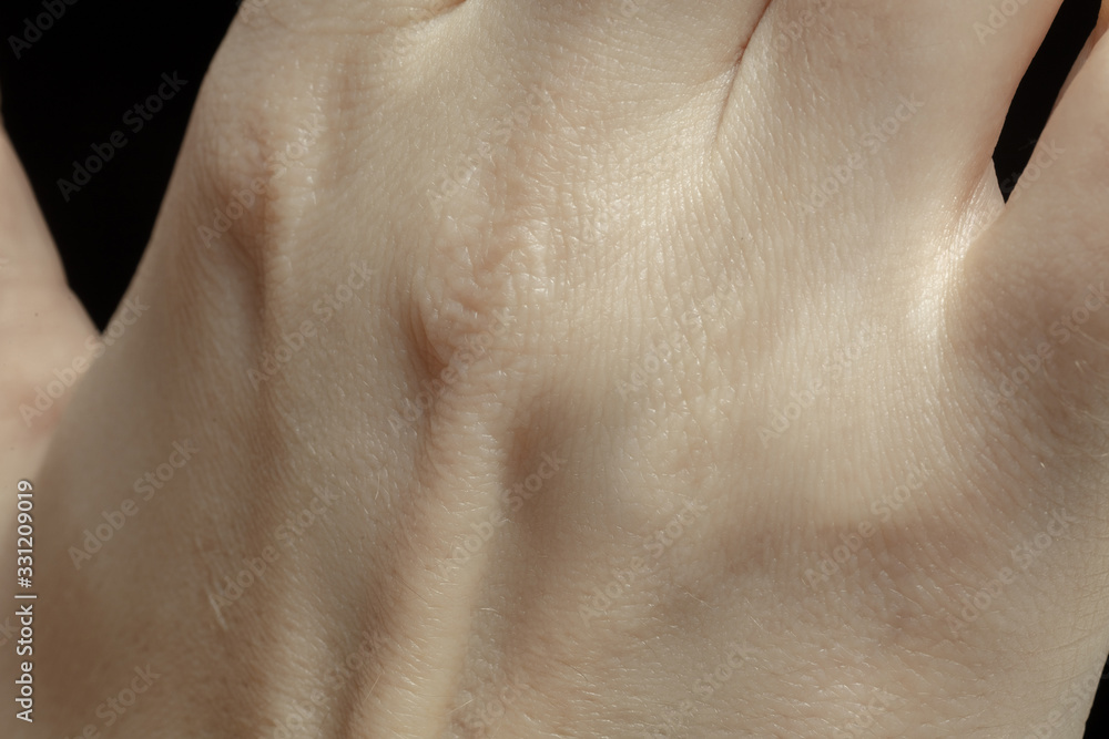 Fototapeta premium Hands. Detailed texture of human skin. Close up shot of young caucasian female body. Skincare, bodycare, healthcare, hygiene and medicine concept. Looks beauty and well-kept. Dermatology.