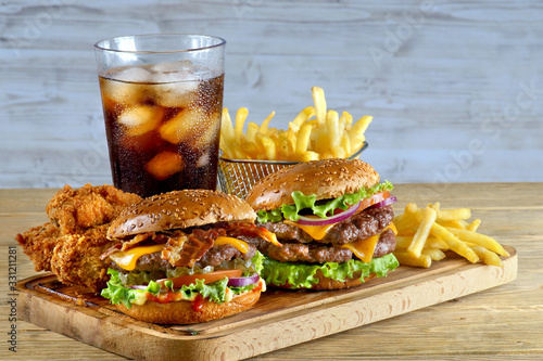 burgers with fries and a glass of Coca-Cola