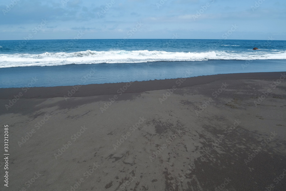 Beach with black volcanic sand on Tenerife island
