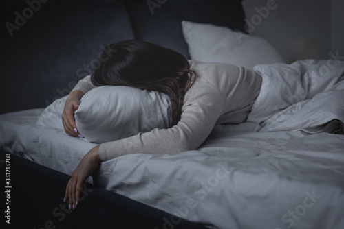 awake woman having insomnia and lying on pillow at night photo