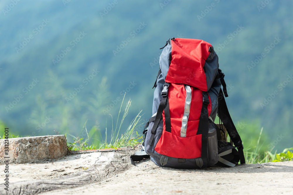 Hiking backpack travel gear on mountain. Items include hiking for travel destination and leisure in vacation. Flat lay of outdoor travel equipment items for mountain camping trip. - obrazy, fototapety, plakaty 