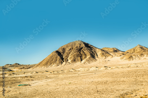 Safari in Egypt Sinai, travel of tourists in the Sahara desert.Road in the desert. Yellow sand and blue sky.