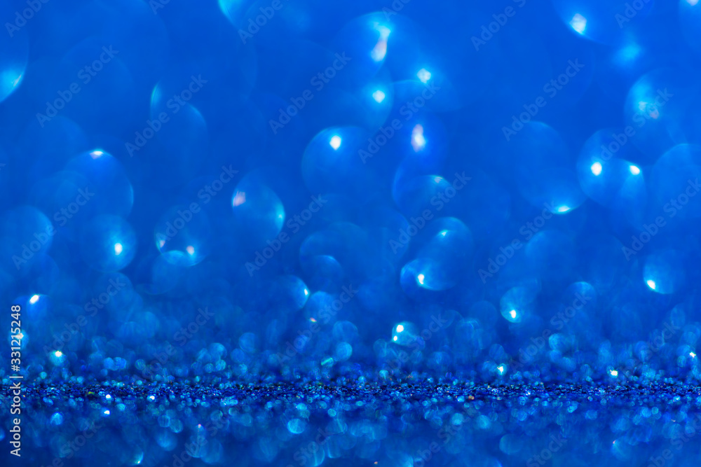 Glitter, sparkle defocused blurred blue background with bokeh lights Glitter, sparkle defocused blurred blue background with bokeh lights