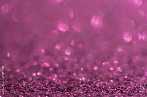 Glitter, sparkle defocused blurred purple violet magenta background with bokeh lights