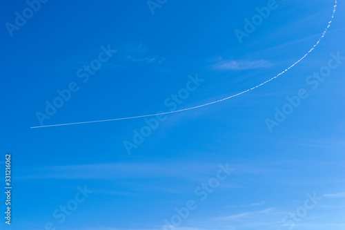 Photography Plane track on blue clear sky,  The airplane turns around and flying back