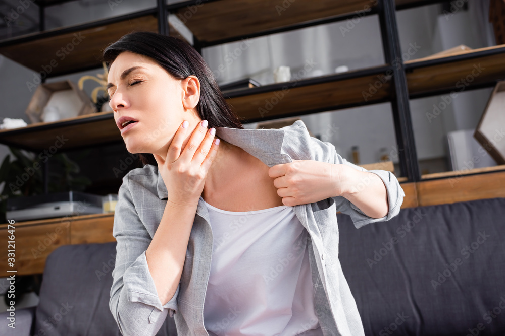 Fototapeta premium asthmatic woman with closed eyes touching neck